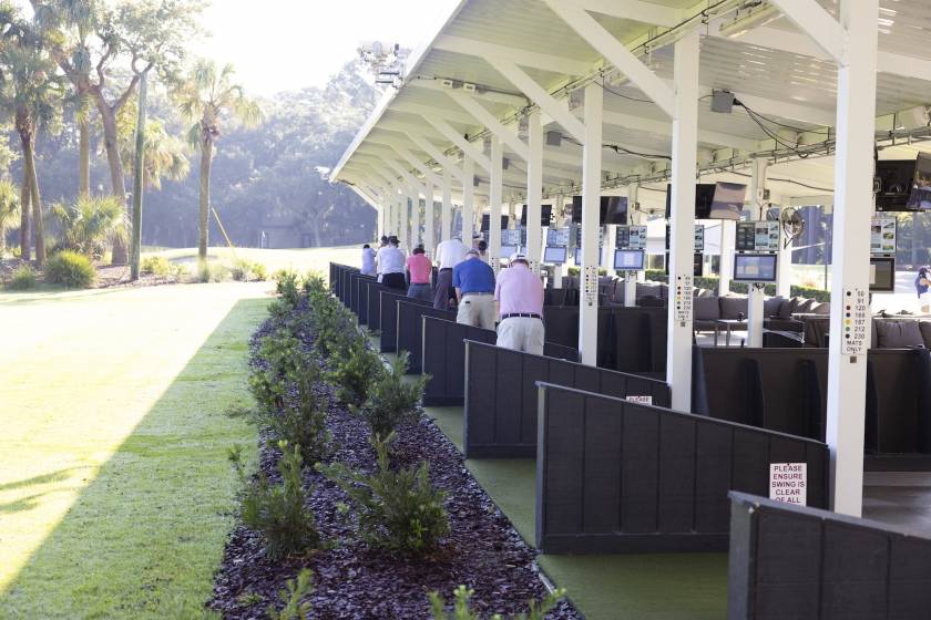 several golfers in the bays of Toptracer Driving Range